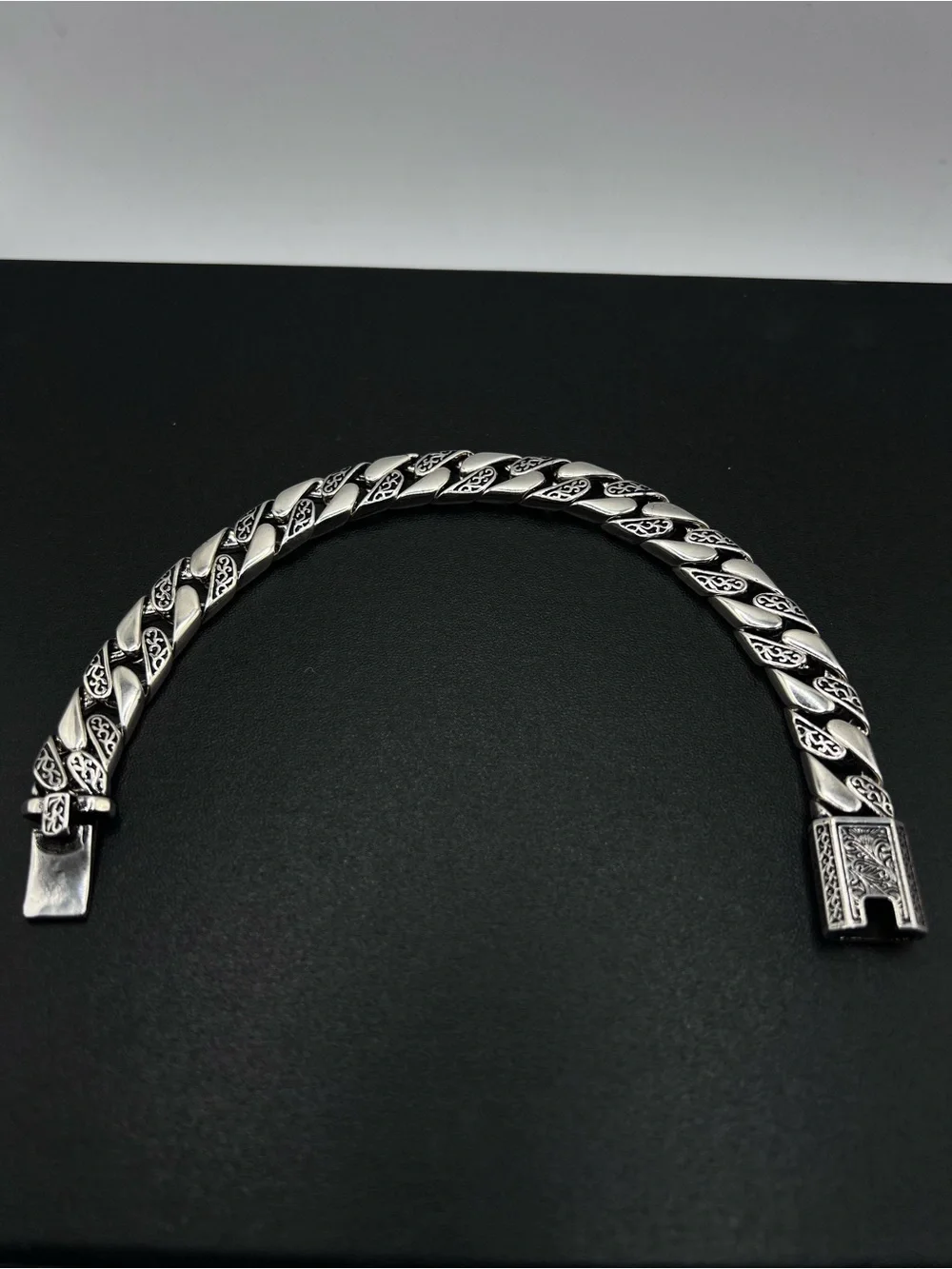 Engraved Cuban Link Bracelet with a secure clasp closure